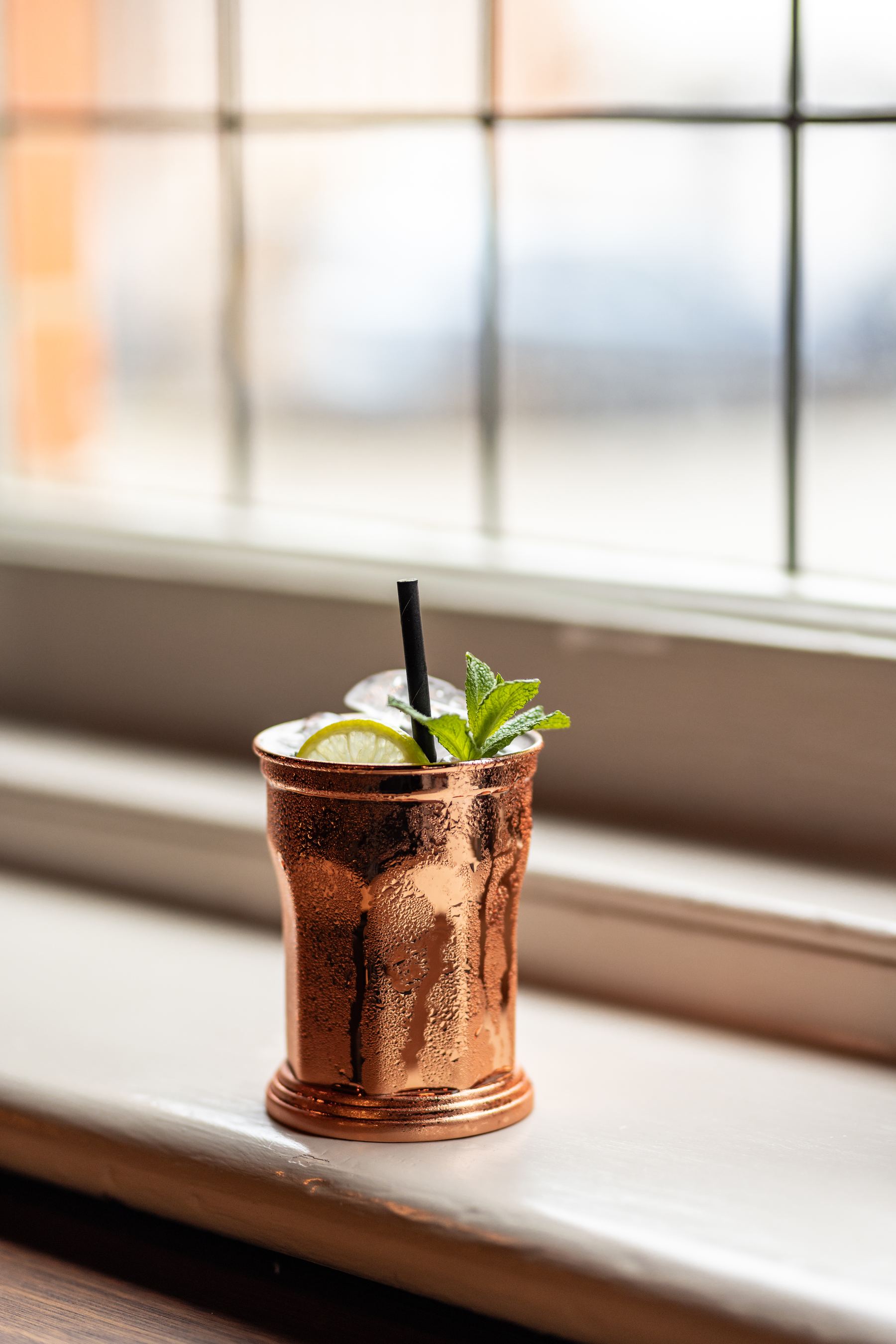 Copper cup cocktail on the windowsill