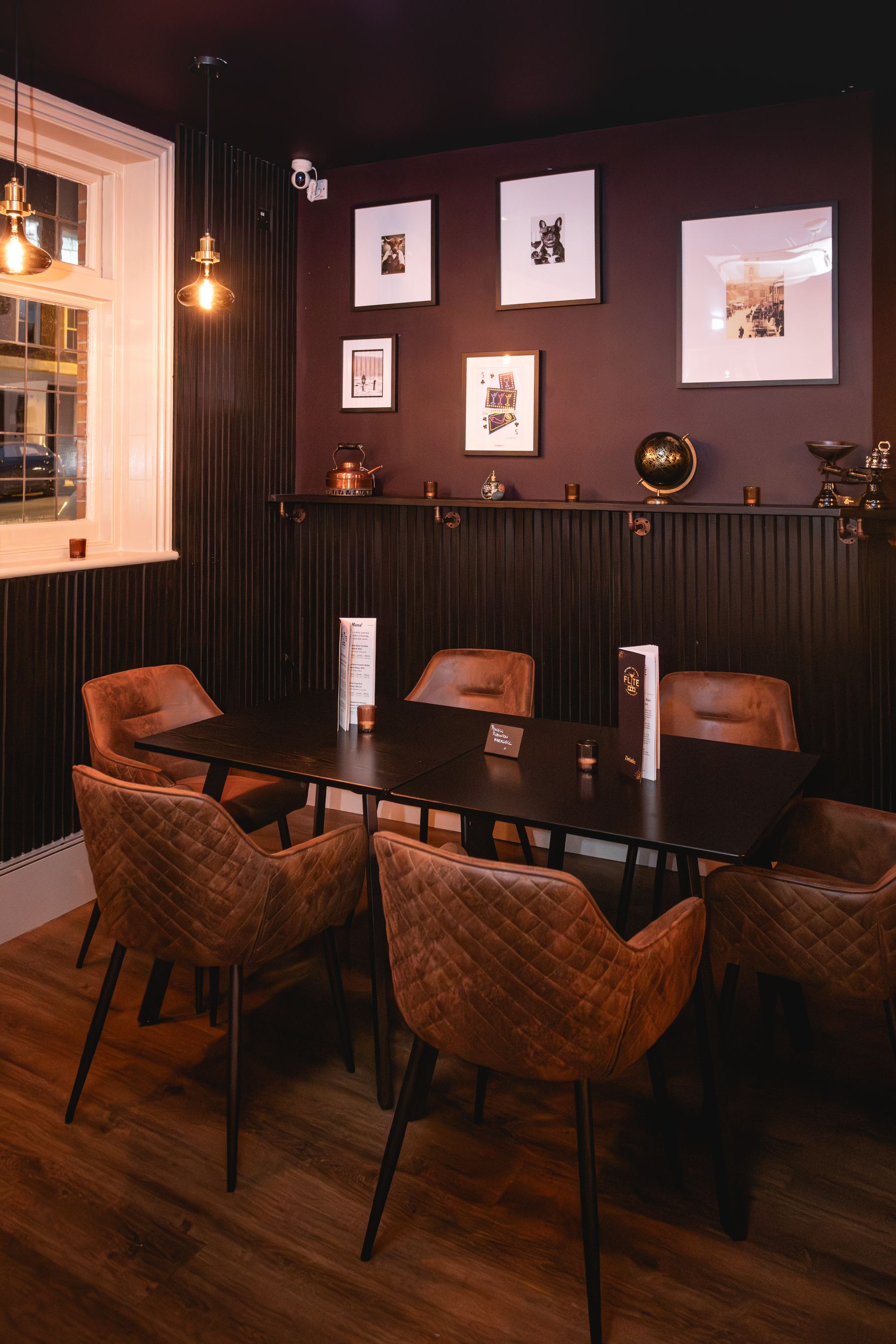 FLYTE bar interior, dining corner with framed art