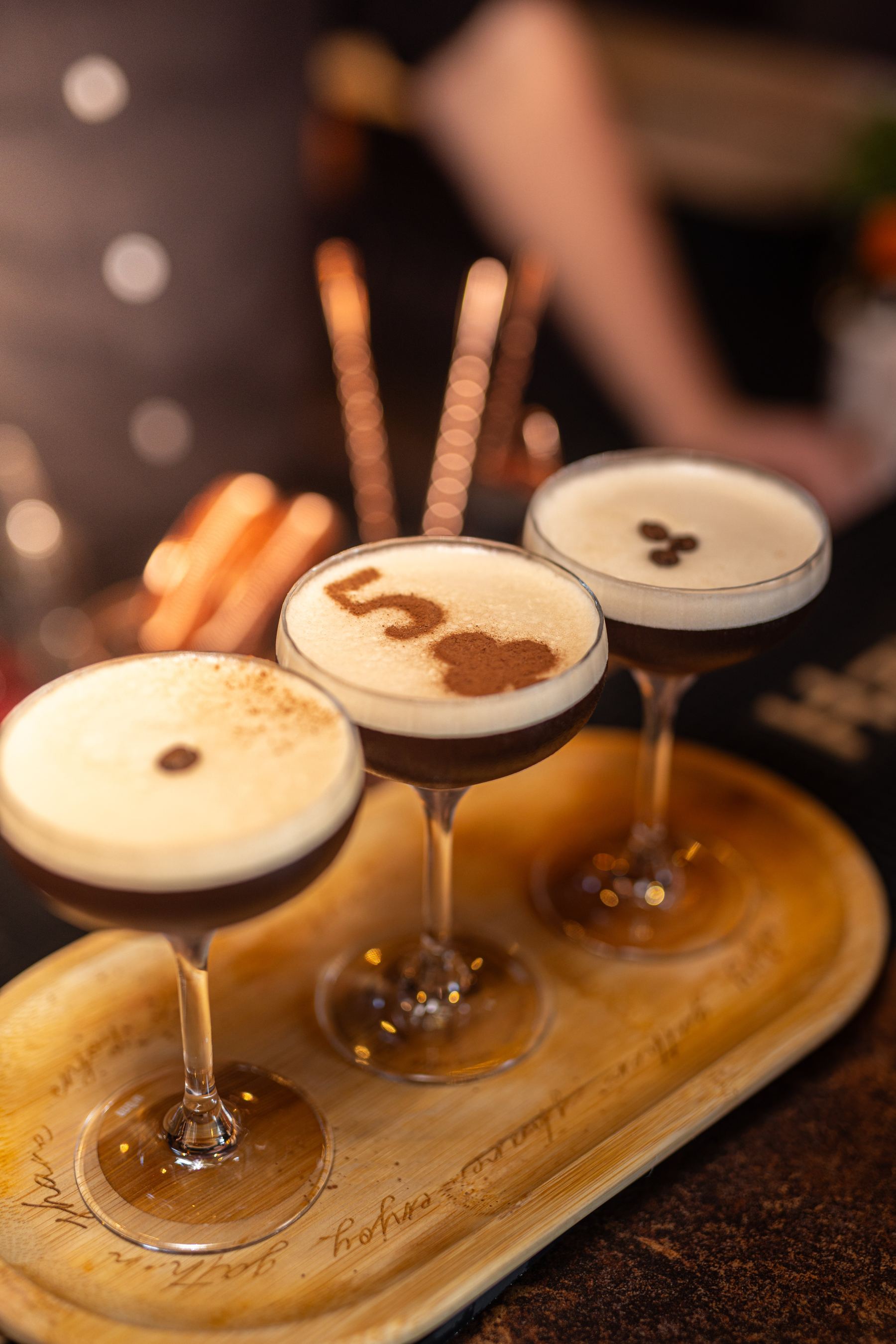 Three espresso martinis served together on a tray