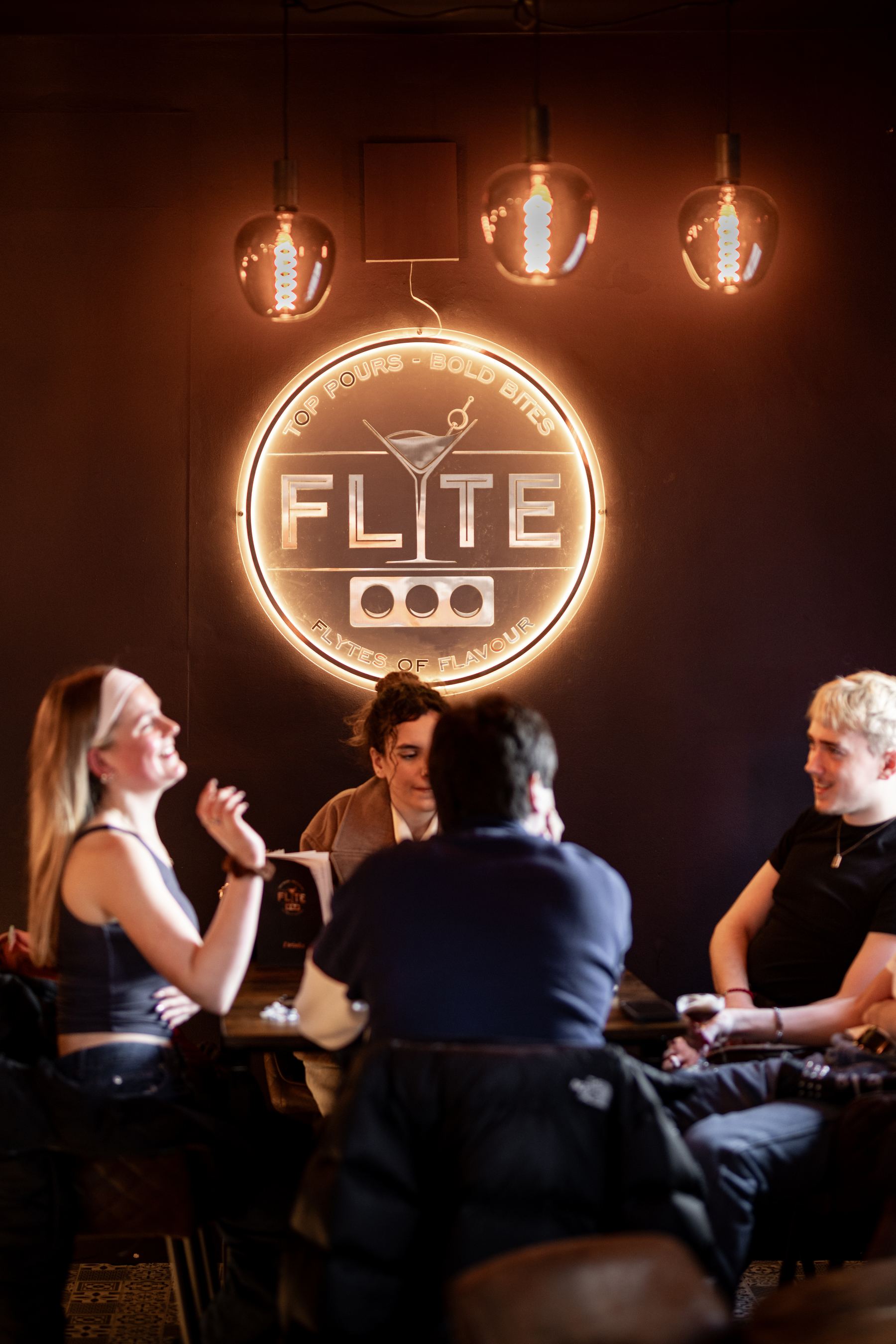 The FLYTE neon badge above the bar